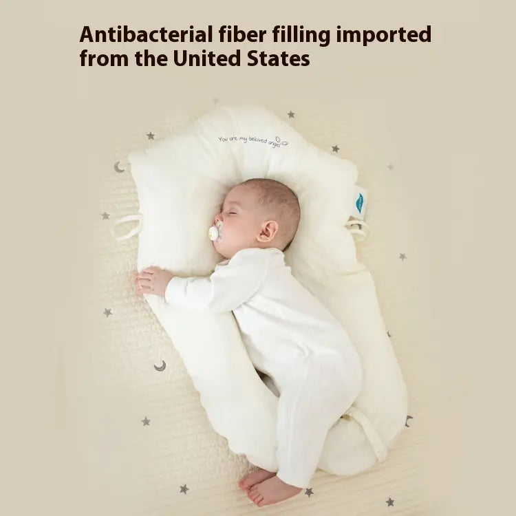 Baby sleeping on a white pillow with text about antibacterial fiber importation.