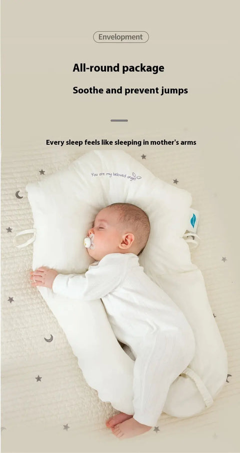 Baby sleeping under a white envelope-shaped pillow with text about providing comfort and preventing jumps.
